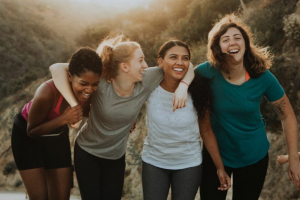 Four happy girl friends in nature